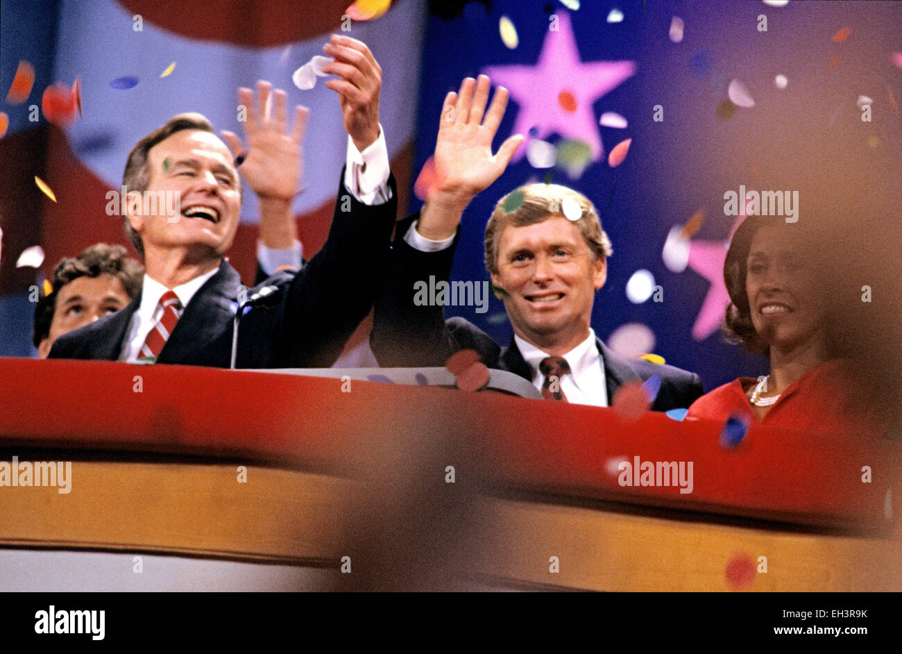 United States Vice President George H.W. Bush, left, and U.S. Senator Dan Quayle (Republican of Indiana), center, on the podium after delivering their speeches accepting their party's nomination for President and Vice President of the United States respectively at the 1988 Republican Convention at the Super Dome in New Orleans, Louisiana on August 18, 1988. At right is Marilyn Quayle. Credit: Howard L. Sachs/CNP - NO WIRE SERVICE - Stock Photo