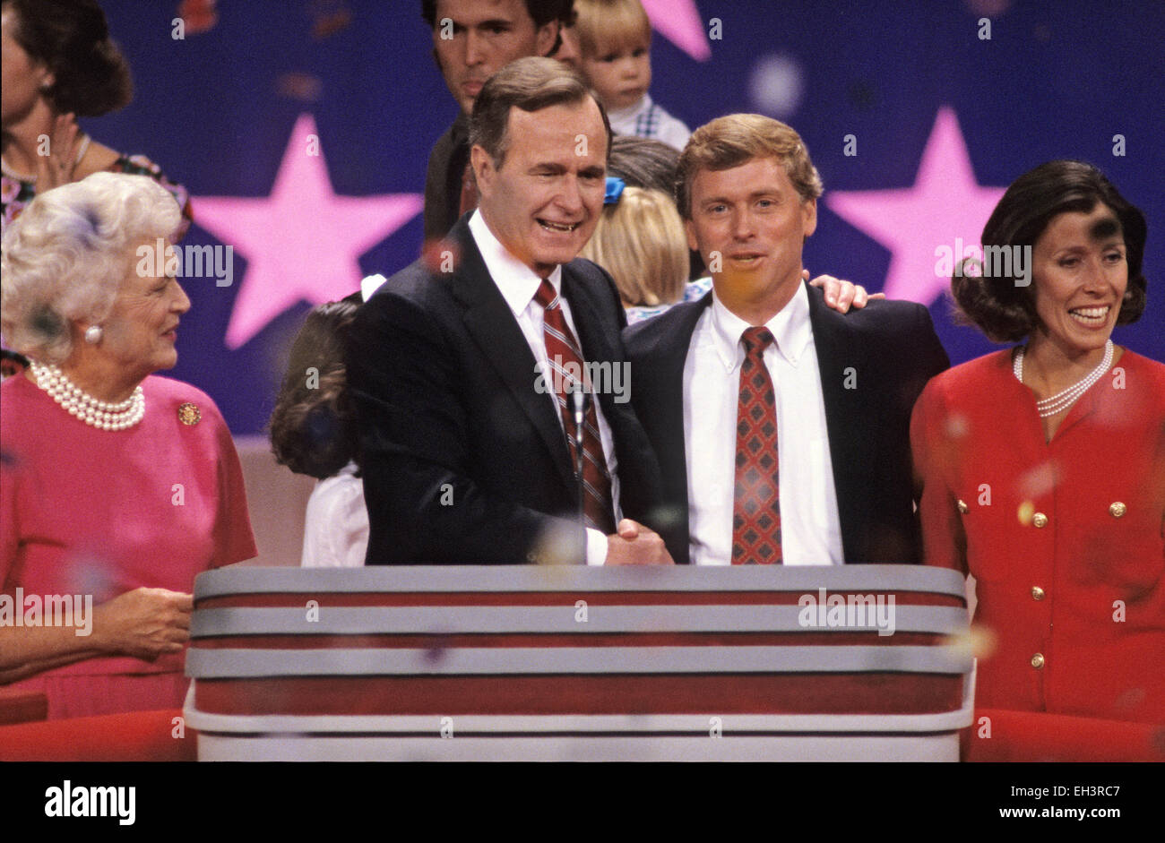 United States Vice President George H.W. Bush, left center, and U.S. Senator Dan Quayle (Republican of Indiana), right center, on the podium after delivering their speeches accepting their party's nomination for President and Vice President of the United States respectively at the 1988 Republican Convention at the Super Dome in New Orleans, Louisiana on August 18, 1988. With them are their wives, Barbara Bush, left, and Marilyn Quayle, right. Credit: Arnie Sachs/CNP - NO WIRE SERVICE - Stock Photo