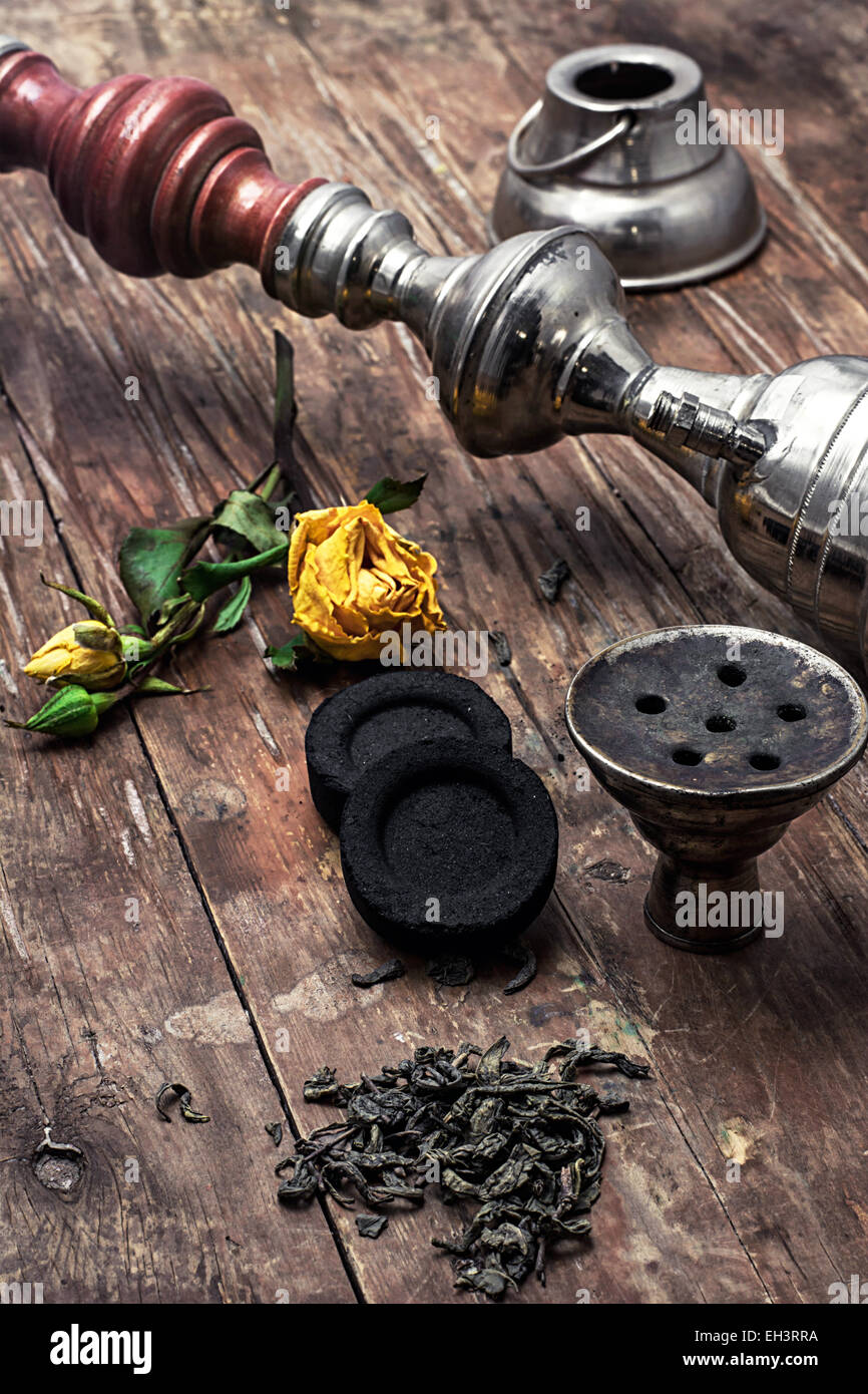 details Shisha and accessories on wooden background.image is tinted in vintage style Stock Photo