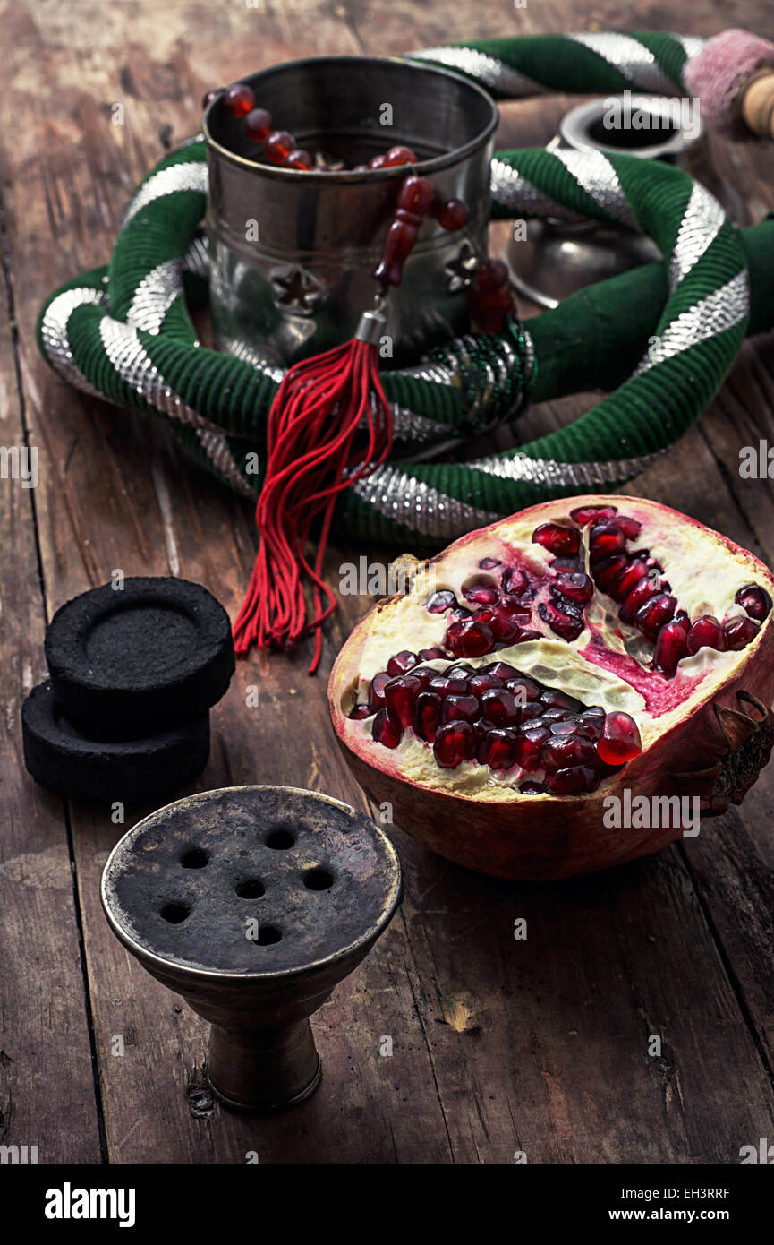 details Shisha and accessories on wooden background.image is tinted in vintage style Stock Photo