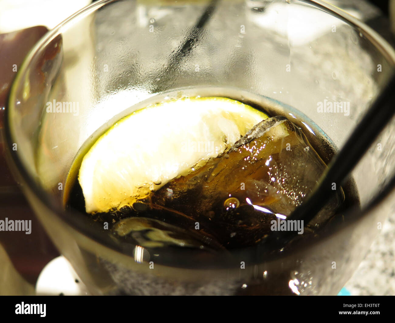 Glass of Coke with ice and straw Stock Photo