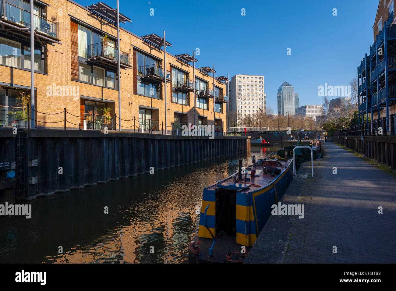 Boats and buildings along the Limehouse cut canal east London Stock