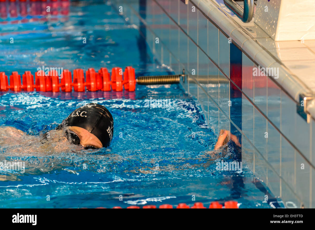 Young man finishes the race at swimming competition in Hoofddorp, Netherlands, September 2014 Stock Photo