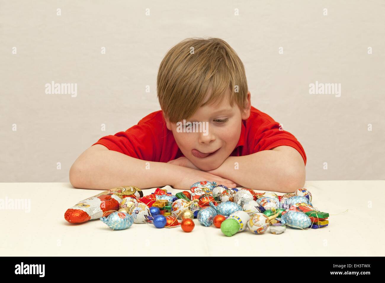 young boy with mouth watering looking at Christmas sweets Stock Photo