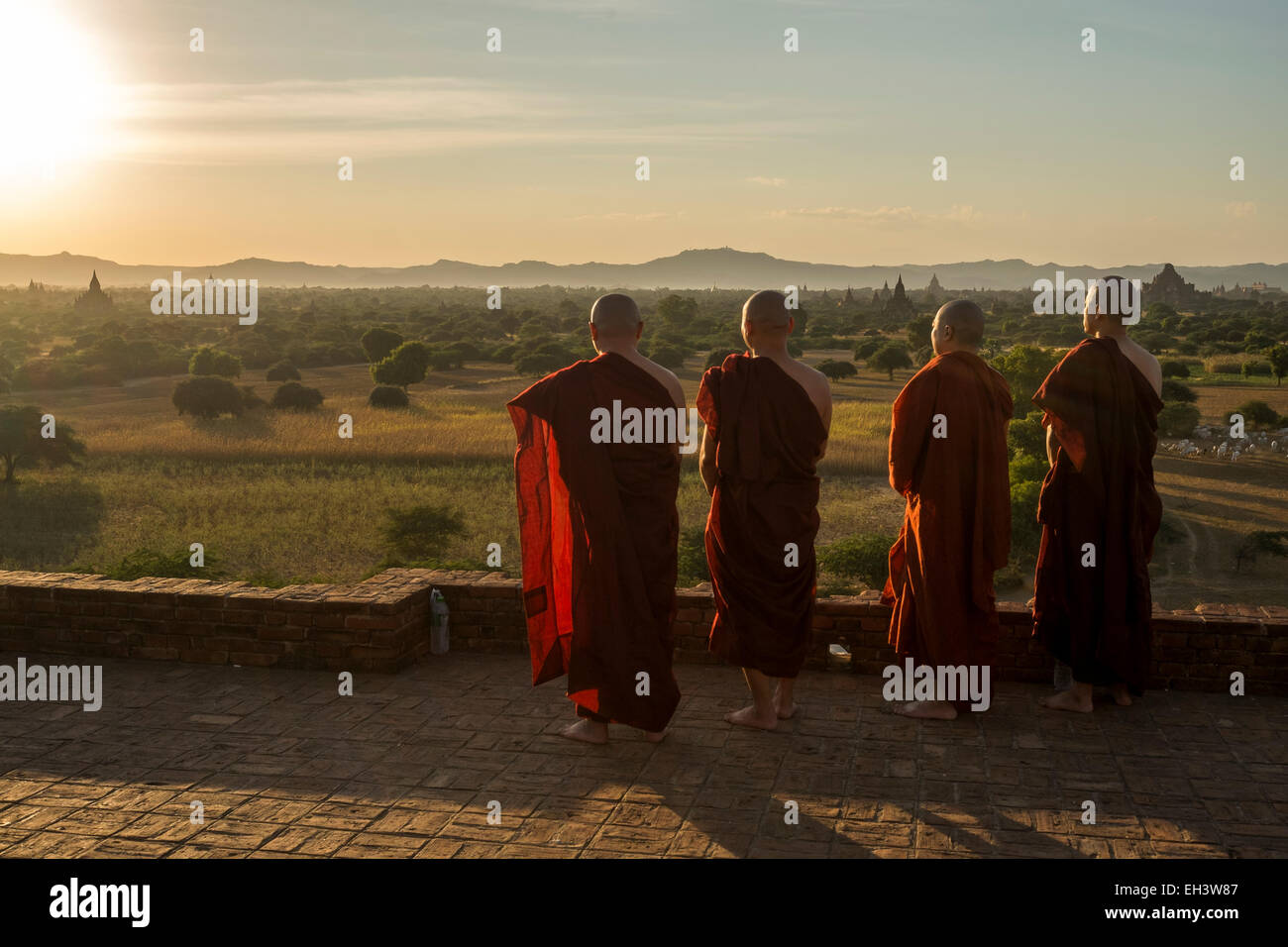 Buddhist monks look out over the temples of Bagan , Myanmar Stock Photo