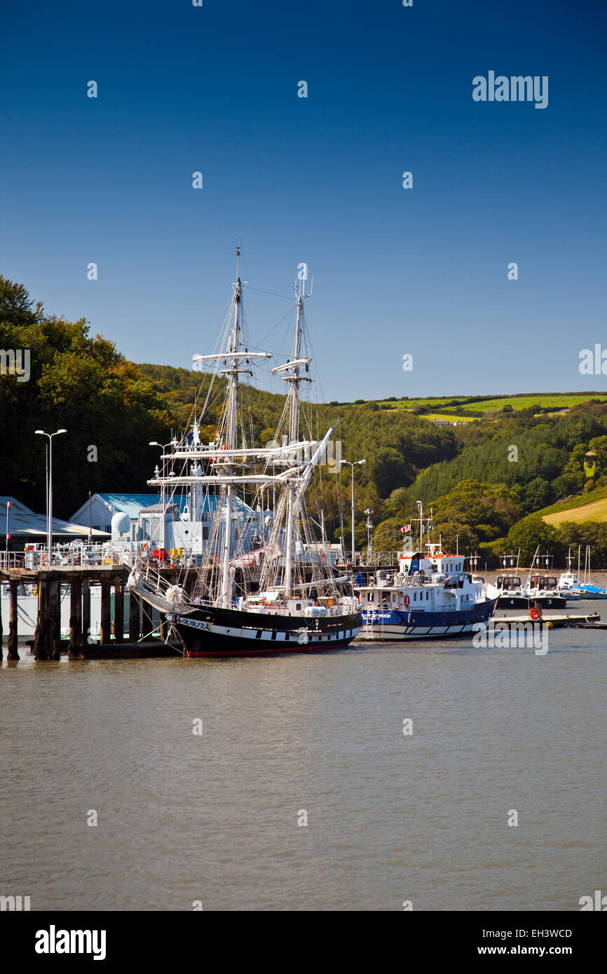 A tall two-masted training ship is moored at the Britannia Royal Naval College quay in Dartmouth, Devon, England, UK Stock Photo