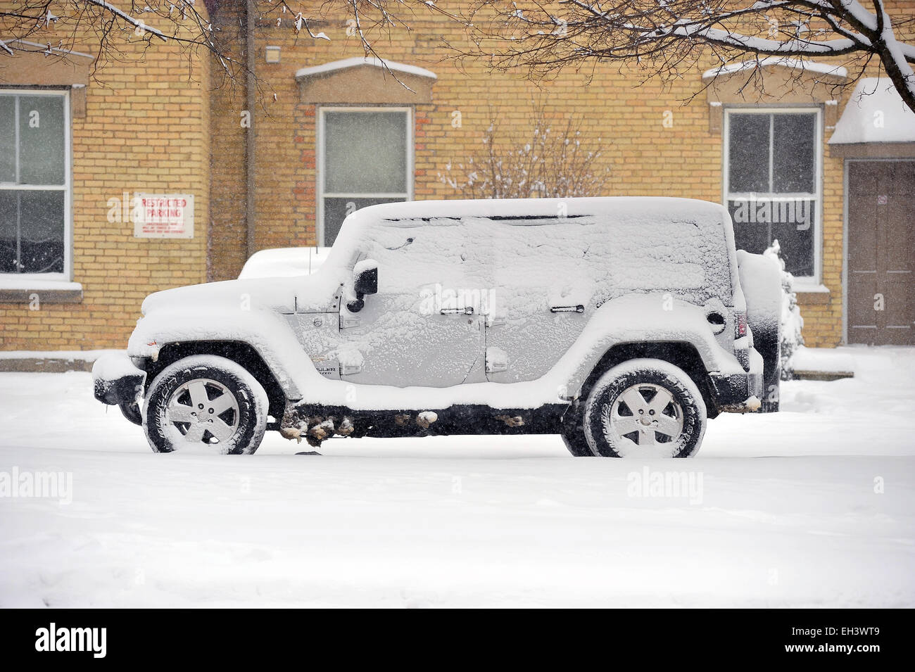A snow covered jeep 4x4 in London, Ontario in Canada. Stock Photo