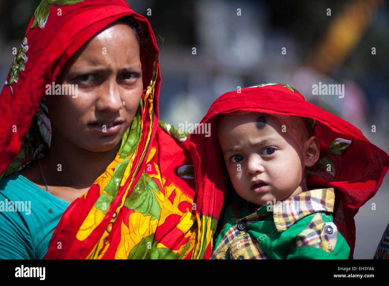 Dhaka, Bangladesh. 6th March, 2015. A women with her child attended to ...