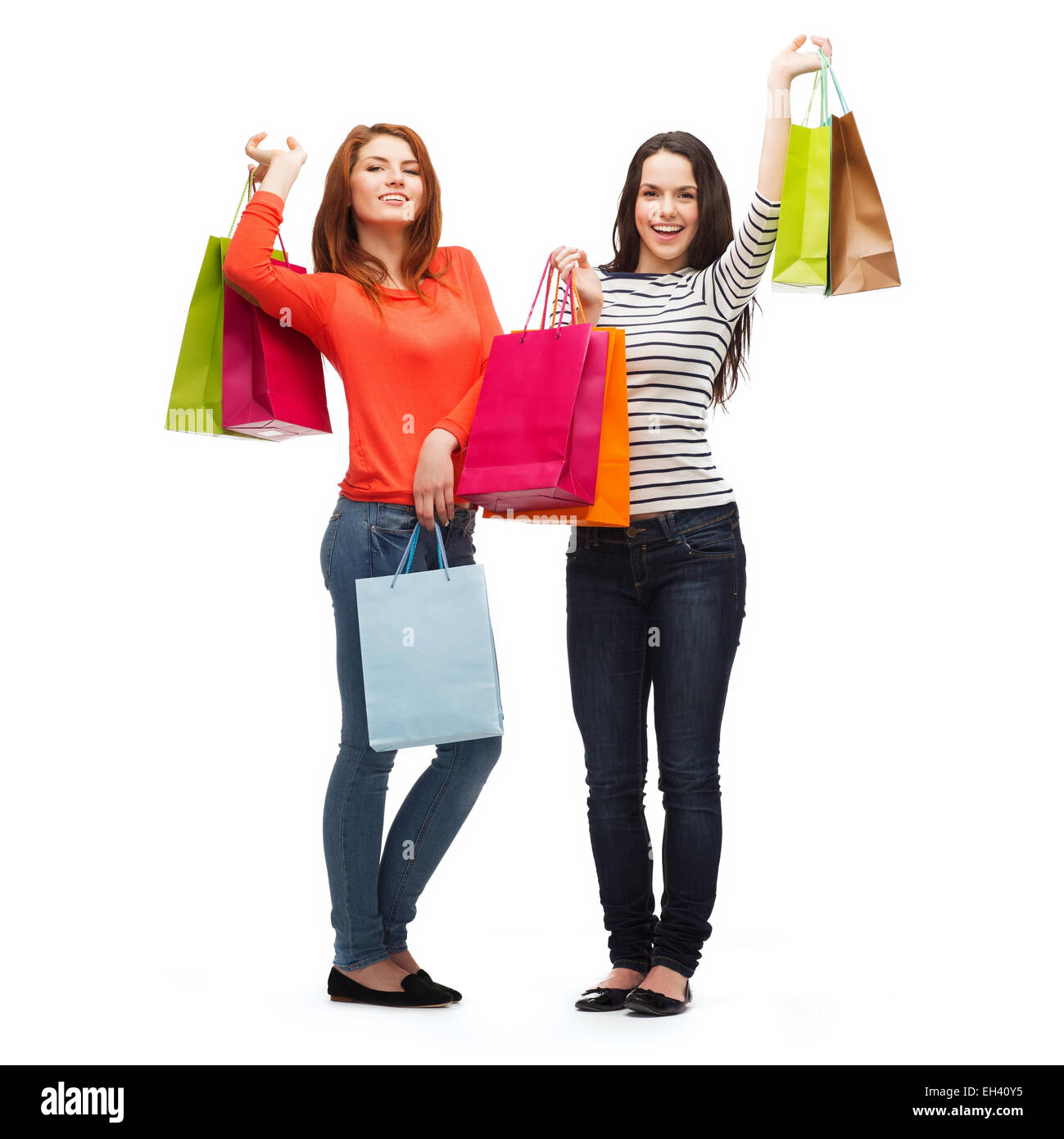 two smiling teenage girls with shopping bags Stock Photo