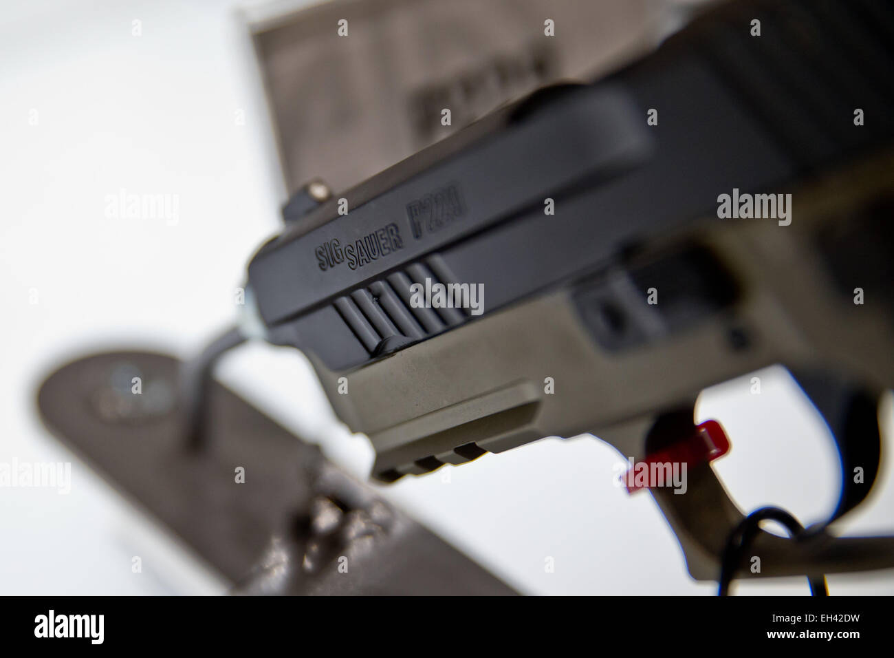 A small fire arm, P229, of weapons manufacturer  Sig Sauer  is on display  at the hunting and sporting gun fair IWA OutdoorClassics in Nuremberg, Germany, 6 March 2015. Photo:  Daniel Karmann/dpa Stock Photo