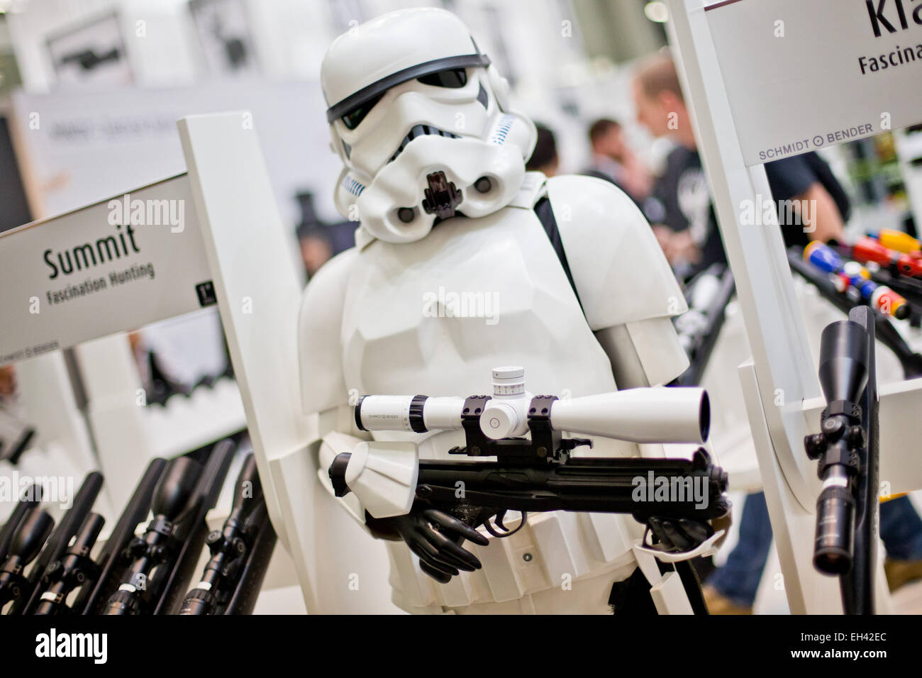 A life-sized doll depicting a storm trooper of the 'Star Wars' films holds a telescopic sight of 'Schmidt und Bender' in its hands at the hunting and sporting gun fair IWA OutdoorClassics in Nuremberg, Germany, 6 March 2015. Photo:  Daniel Karmann/dpa Stock Photo