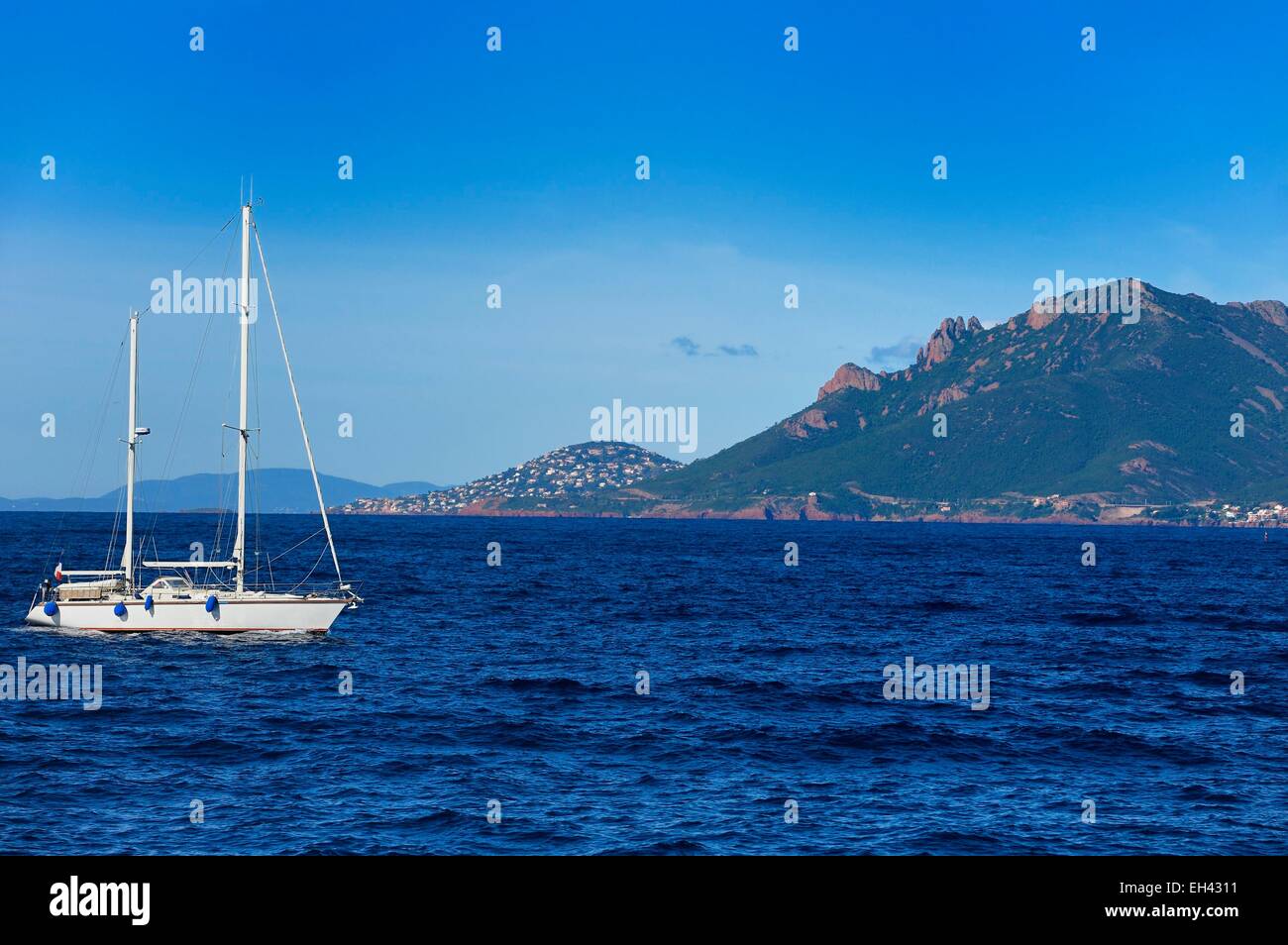 France, Alpes Maritimes, sailboat off the Lerins Islands and the Esterel Mountains in the background Stock Photo