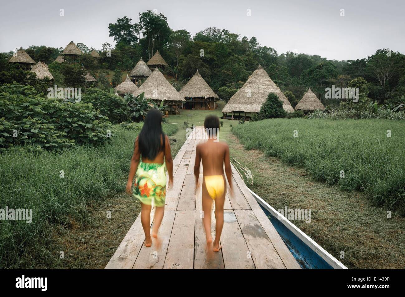 Panama, Darien province, Darien National Park, listed as World Heritage by UNESCO, Embera indigenous community, a boy and a girl on a boardwalk heading towards a village Stock Photo