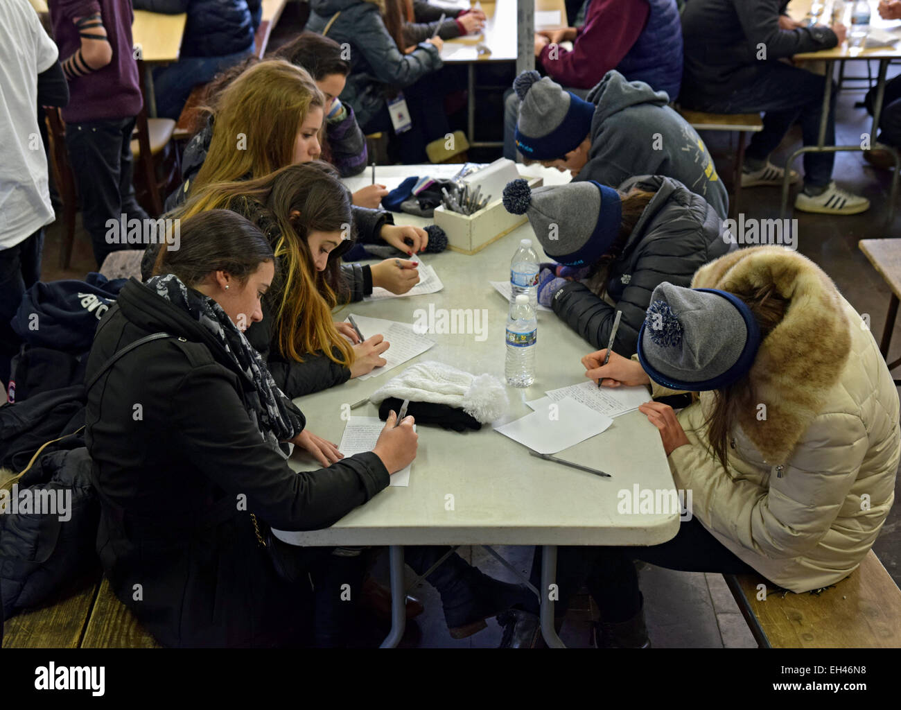 Jewish teenage girls writing personal prayers at a Shabbaton at the Ohel in Cambria Heights, Queens, New York City. Stock Photo