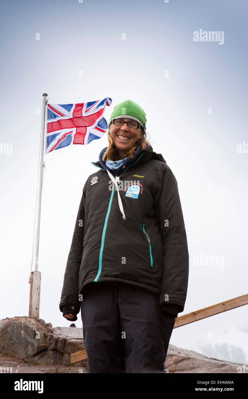 Antarctica, Goudier Island, Port Lockroy, Antarctic Heritage Trust worker with Union Jack UK flag Stock Photo