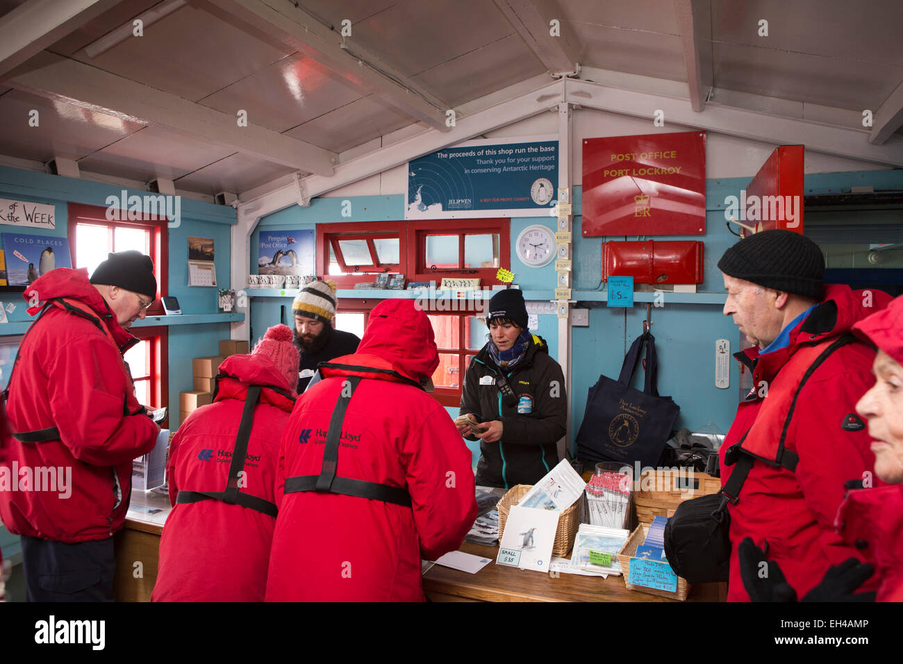 Antarctica, Goudier Island, Port Lockroy British base, worker Sarah Aufrett and postmaster Stephen Skinner serving tourists Stock Photo