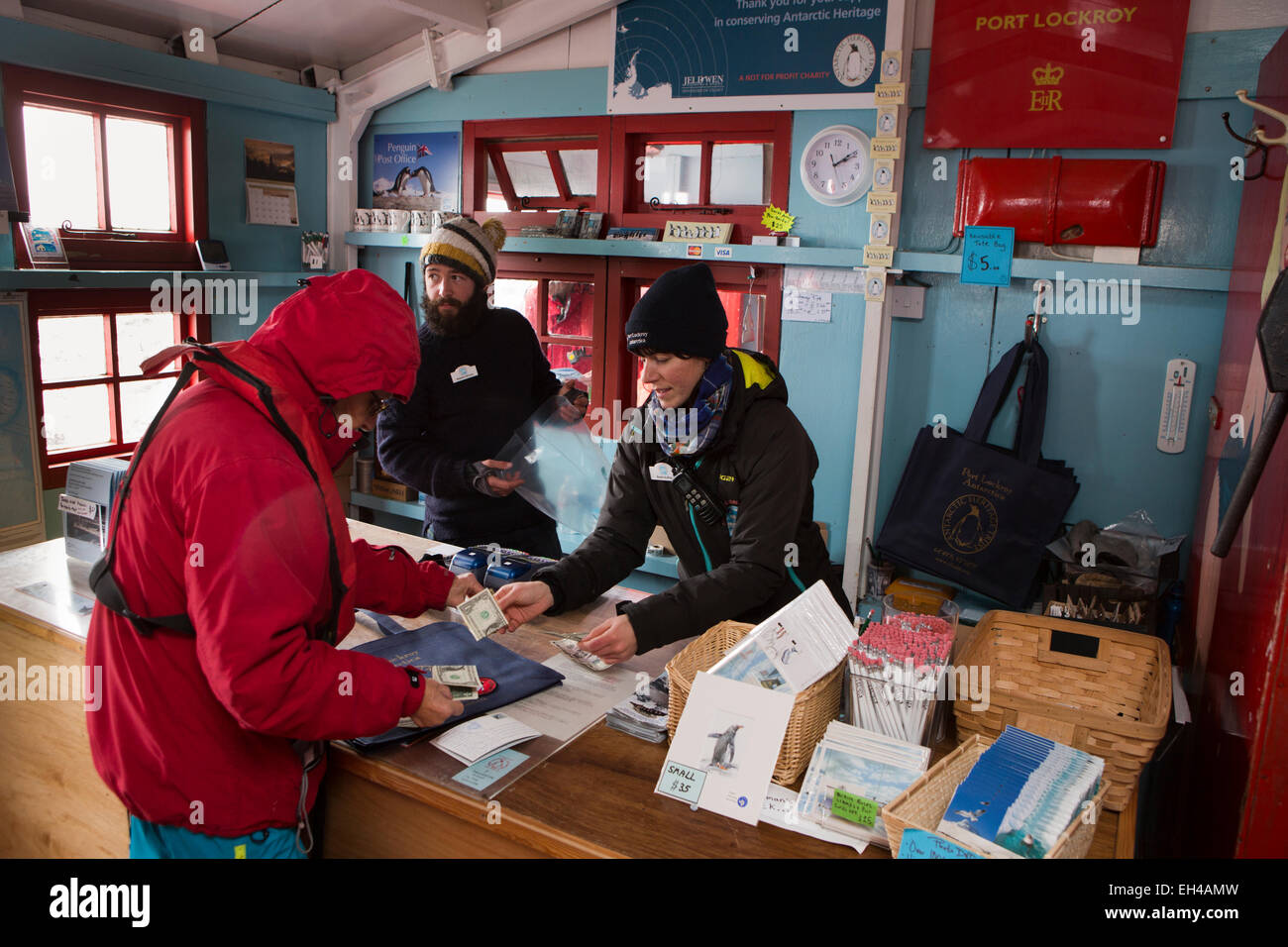 Antarctica, Goudier Island, Port Lockroy British base, worker Sarah Aufrett and postmaster Stephen Skinner serving in shop Stock Photo