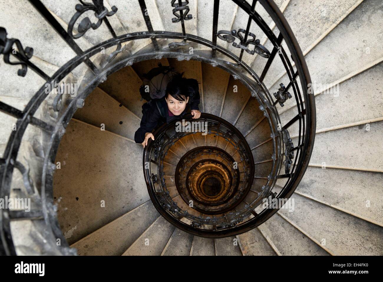 Hungary, Budapest, Pest, Belvaros, listed as World Heritage by UNESCO, asian woman in the spiral (helical) staircase in the tower of the Basilica of Saint Stephen Stock Photo