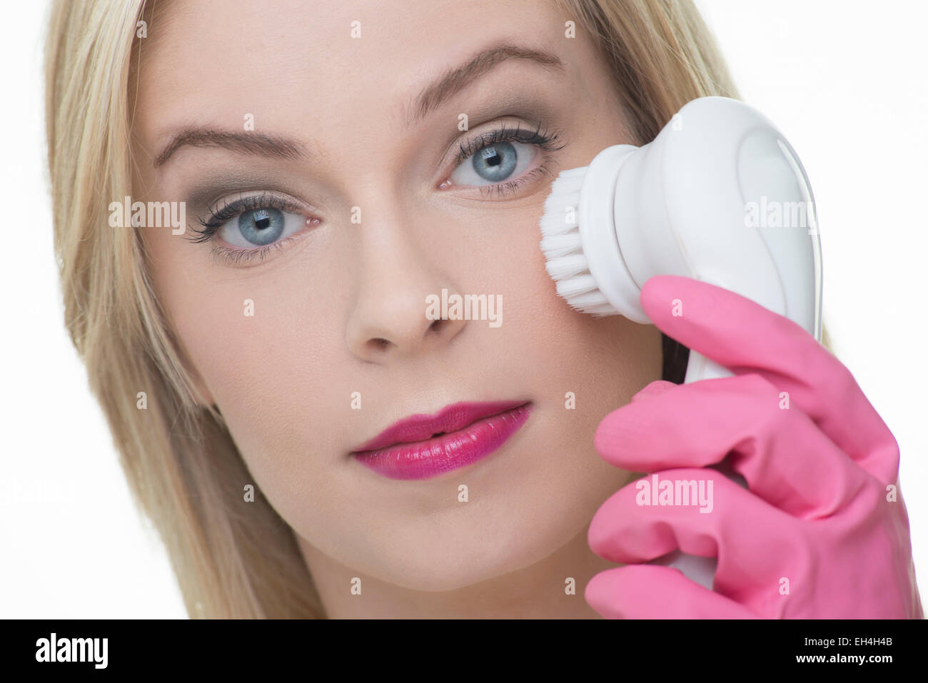 woman cleansing her face using a deep cleansing brush Stock Photo