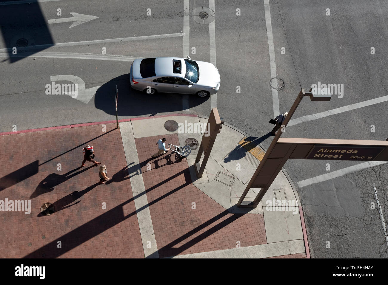 Looking down onto a street corner pedestrians crossing Stock Photo