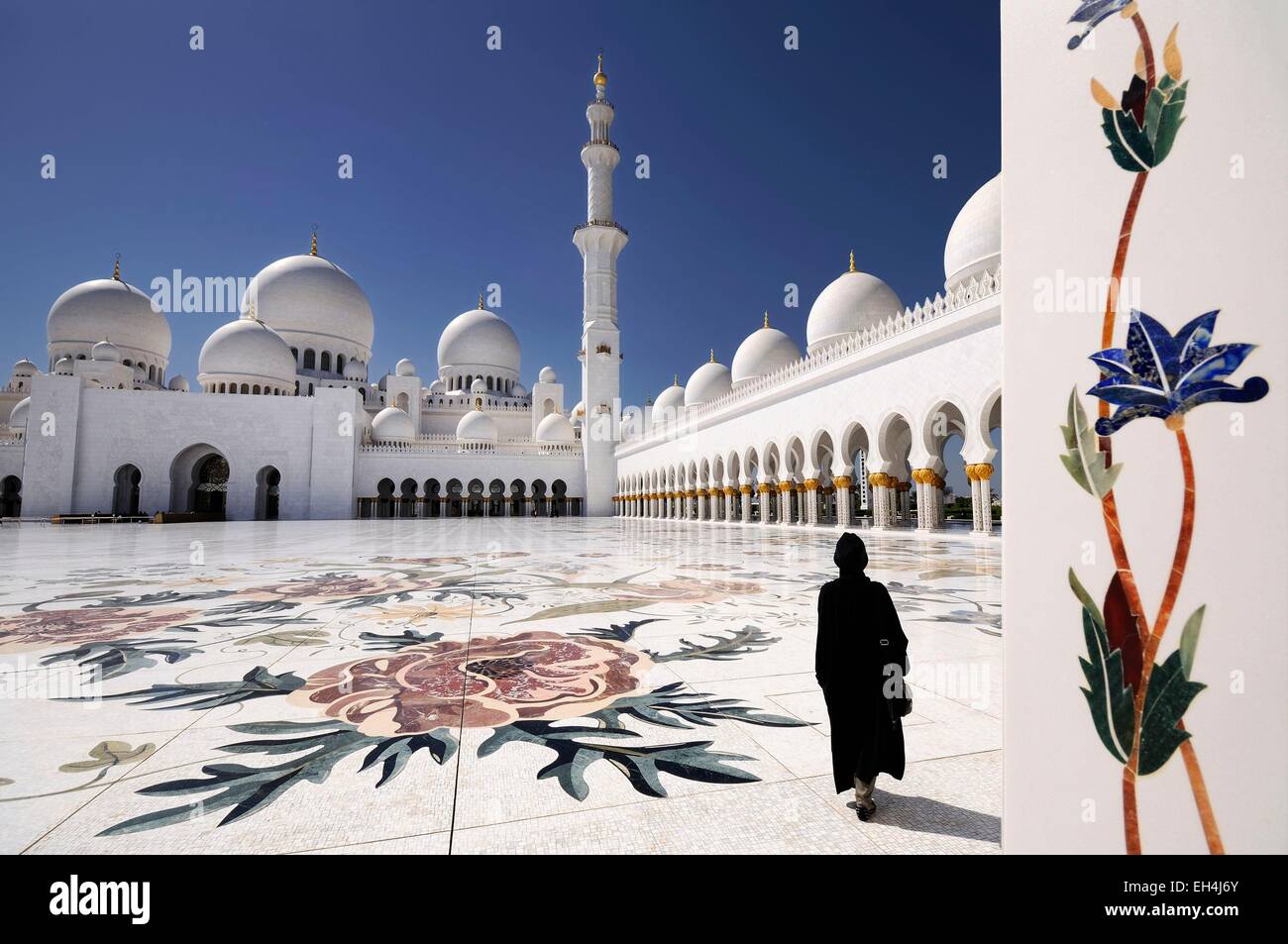 United Arab Emirates, Abu Dhabi, Sheikh Zayed Grand Mosque, woman wearing an abaya in the mosque courtyard Stock Photo