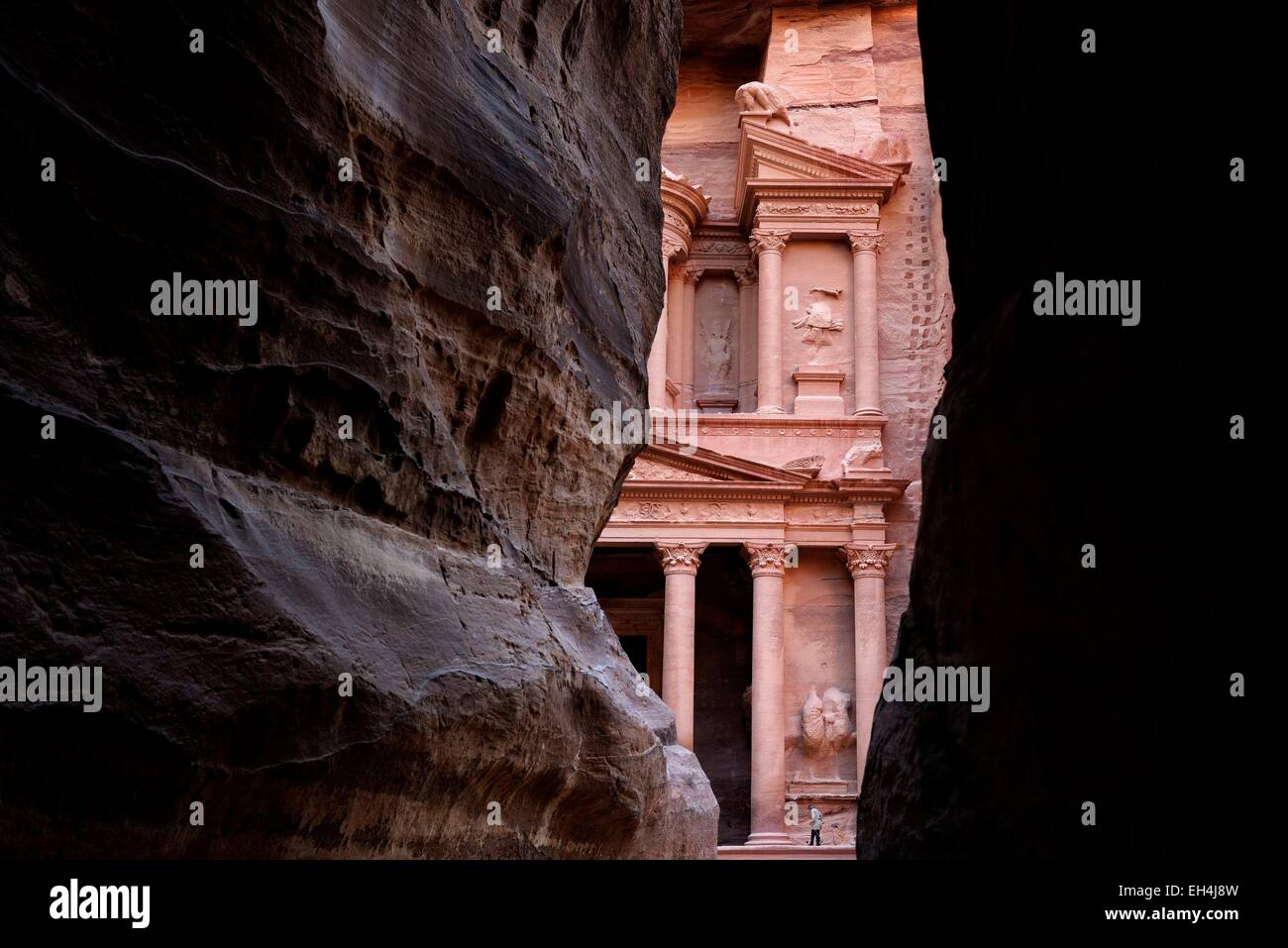 Jordan, Nabataean archeological site of Petra, listed as World Heritage by UNESCO, the famous and elaborately carved façade of Al Khazneh (the Treasury), carved out of a sandstone rock face, viewed from the end of the Siq Stock Photo