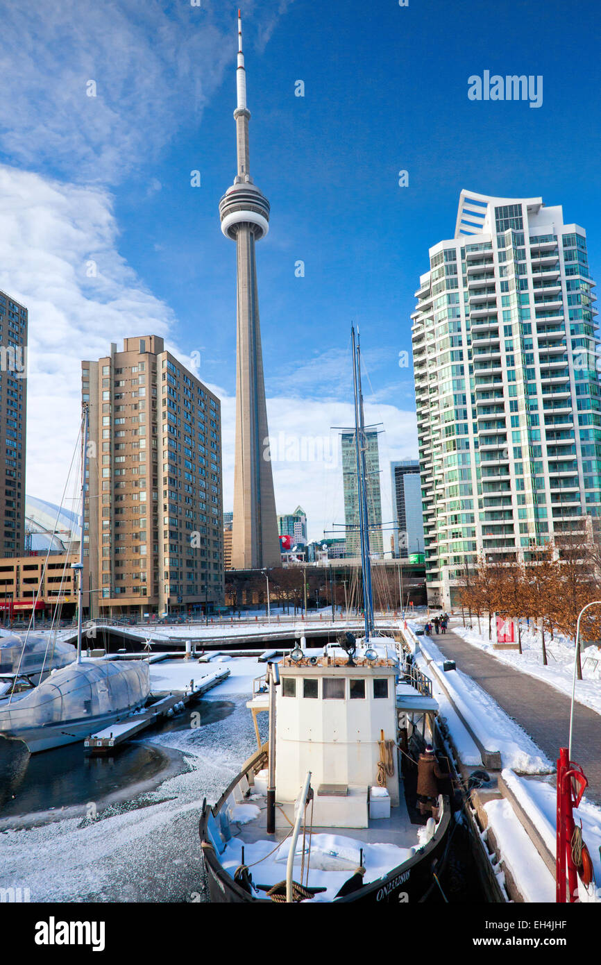 Harbor in Toronto;Capital City of Ontario;Canada in the winter of 2015; Harbor with ice and snow and boats and CN tower Stock Photo