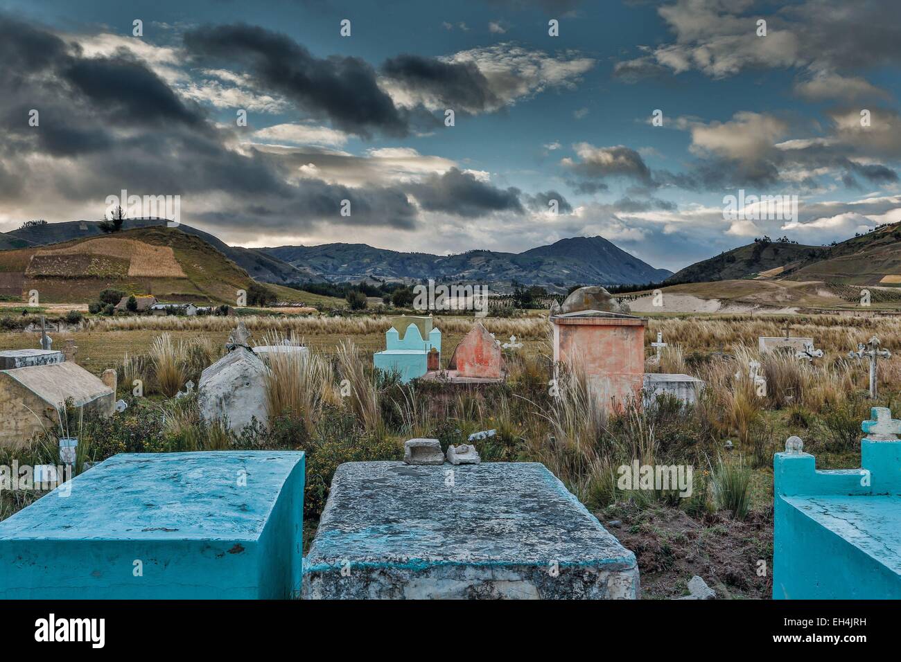 Ecuador, Cotopaxi, Tigua, Andean landscape of a rural cemetery on a plain in a mountainous setting under a stormy sky Stock Photo