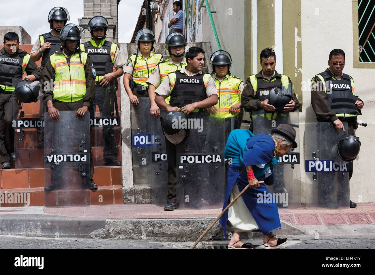 Ecuador, Imbabura, Cotacaxi, Intyrami day, old woman past the police cordon during the festivities Stock Photo