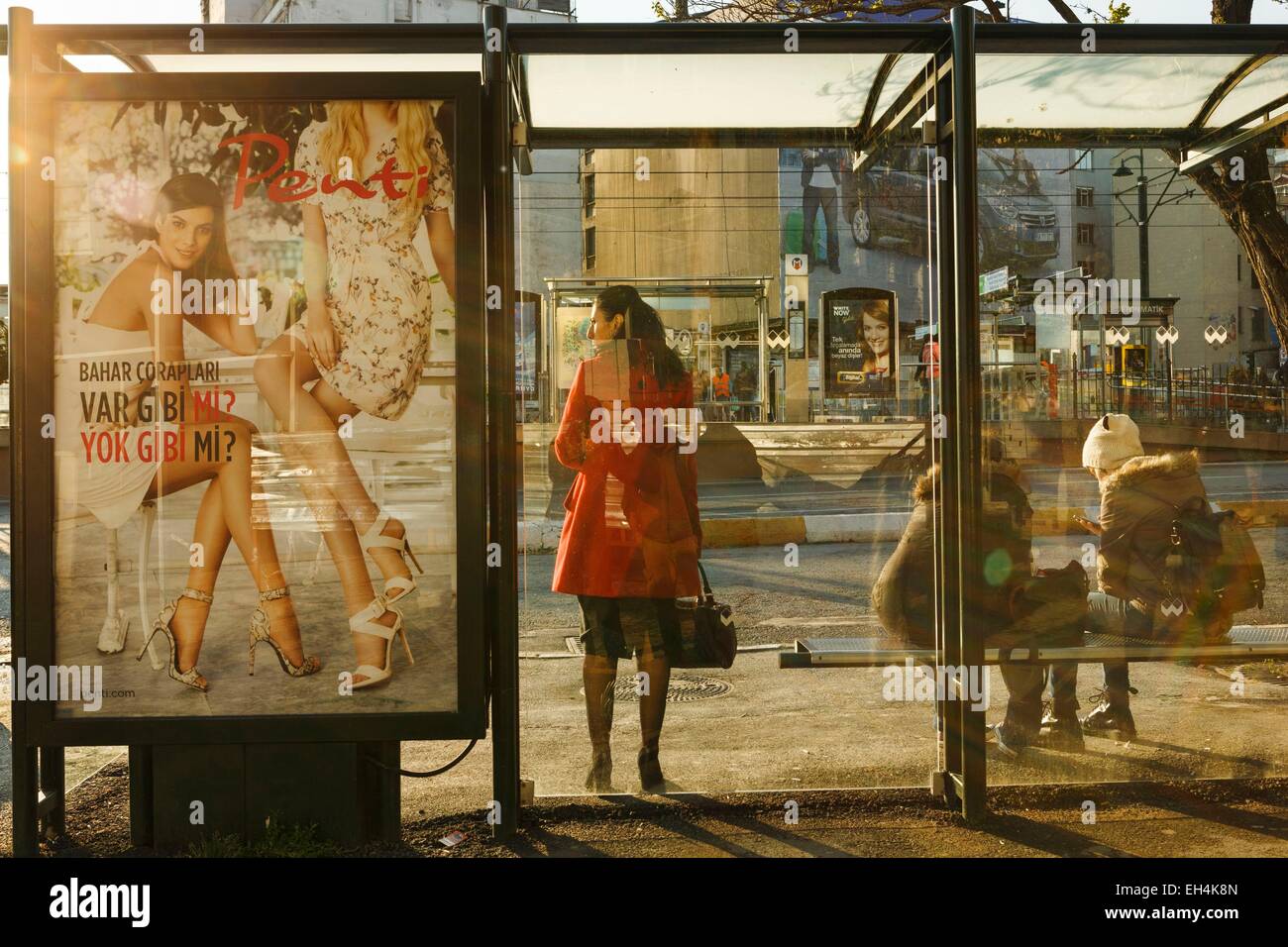 Turkey, Istanbul, Karakoy district, some users in a bus stop at sunset Stock Photo