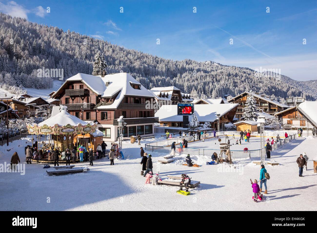 France, Haute-Savoie, Morzine, the valley of Aulps, ski slopes of the Portes du Soleil, ice rink and merry-go-round place of Baraty Stock Photo