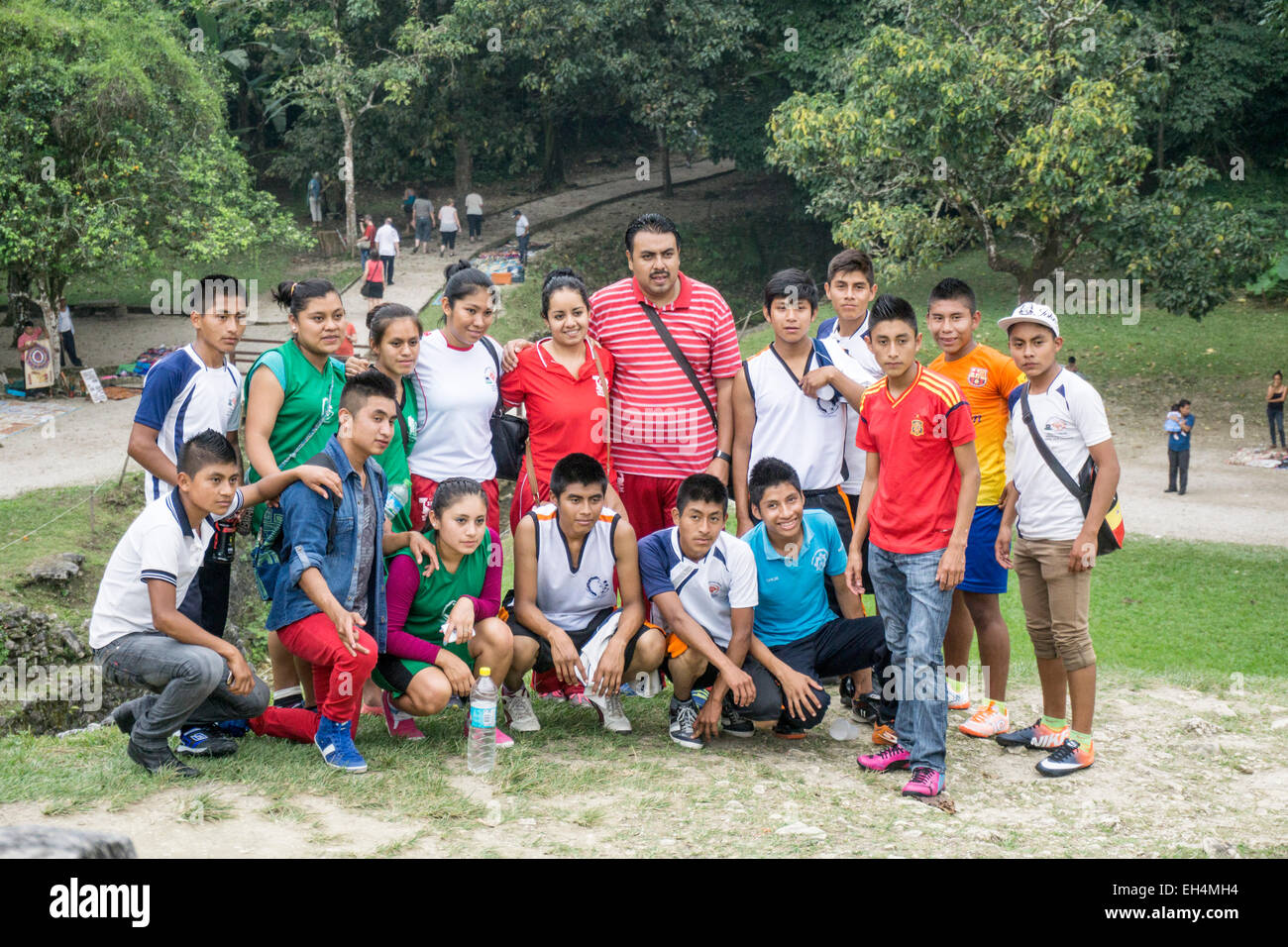 eager happy group of Mexican teenagers with teacher pause for a photo on patio of Palace Palacio on school outing to Palenque Stock Photo