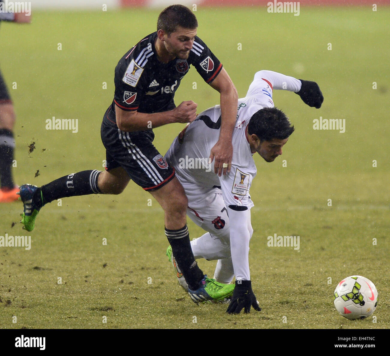 March 4, 2015 - Washington, DC, USA - 20150304 - D.C. United defender Chris Korb (22), left, battles Alajuelense forward Alejandro Aguilar (7), as they go after the ball in the second half of a CONCACAF quarterfinal at RFK Stadium in Washington. United defeated Alajuelense, 2-1. Alajuelense advanced to the semifinals on the two-game aggregate, 6-4. (Credit Image: © Chuck Myers/ZUMA Wire) Stock Photo