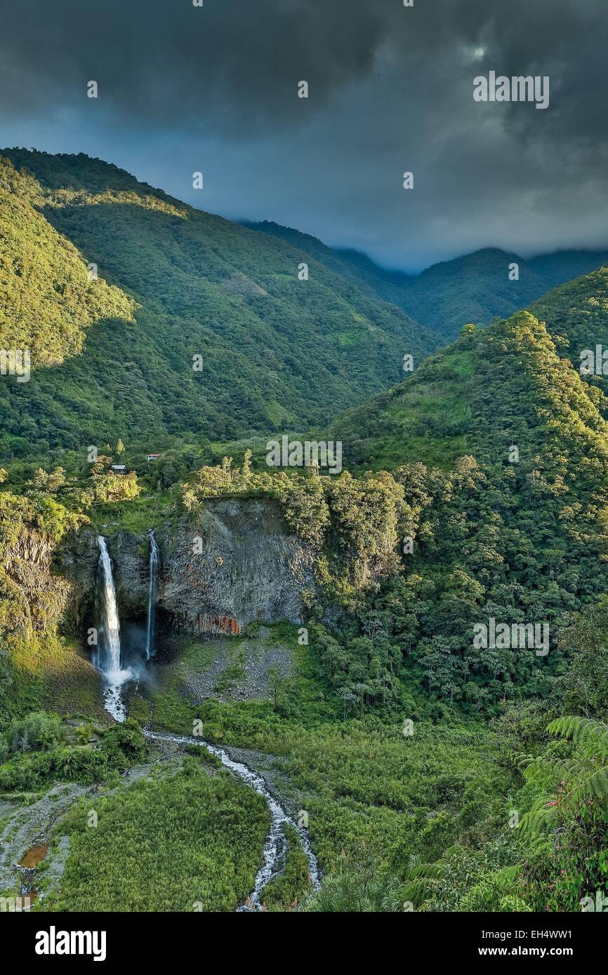 Ecuador, Tungurahua, Banos de Agua Santa, landscape with a waterfall in a tropical greenery caskets at sunset on a stormy sky Stock Photo