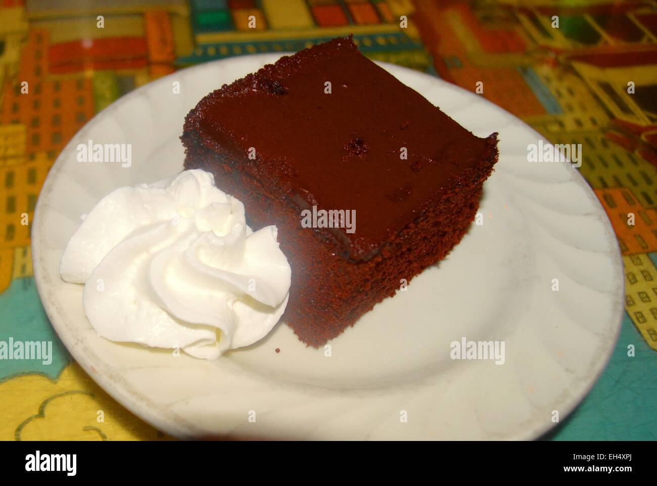 Scrumptious chocolate cake with whipped cream Stock Photo