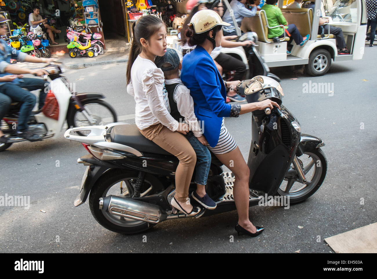 child,children,Family, on a scooter. pollution,noise, traffic,Ha Noi,Hanoi, Vietnam, Stock Photo
