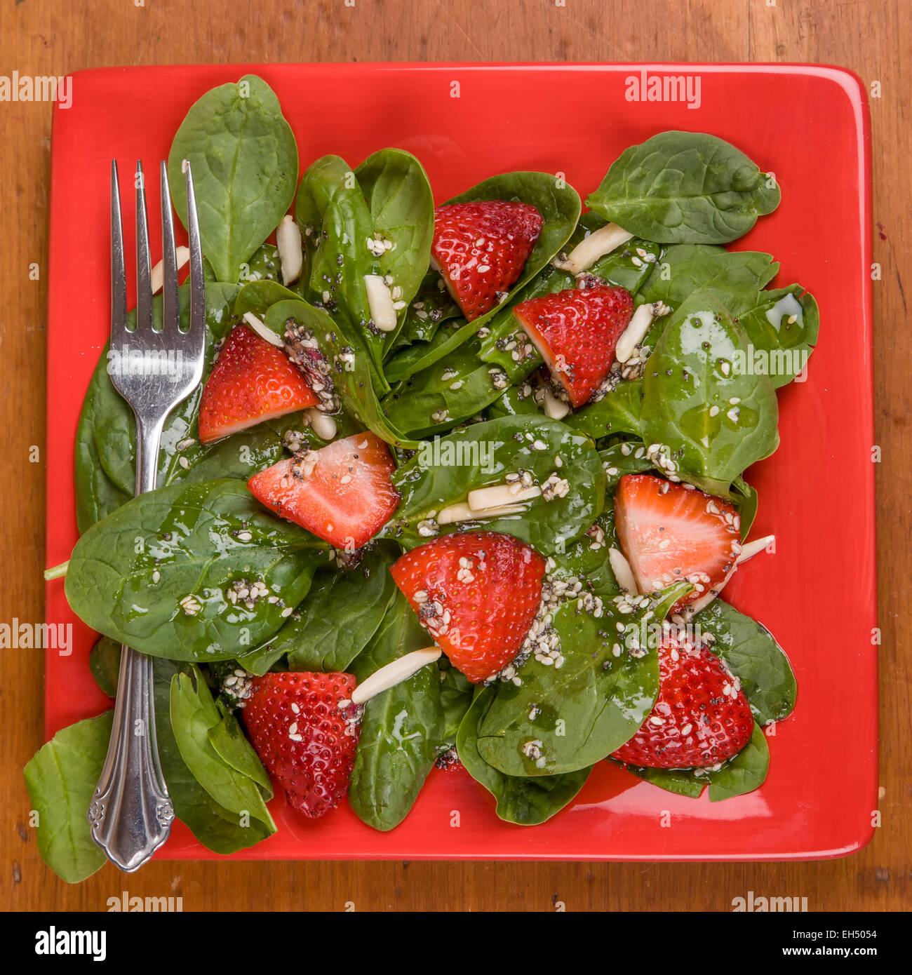 Spinach strawberry salad with homemade dressing and almonds. Stock Photo