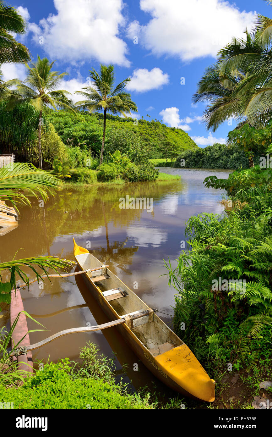 Canoes moored at entrance to Komokila Historic Village on Wailua River Valley, Kauai, Hawaii, USA Stock Photo