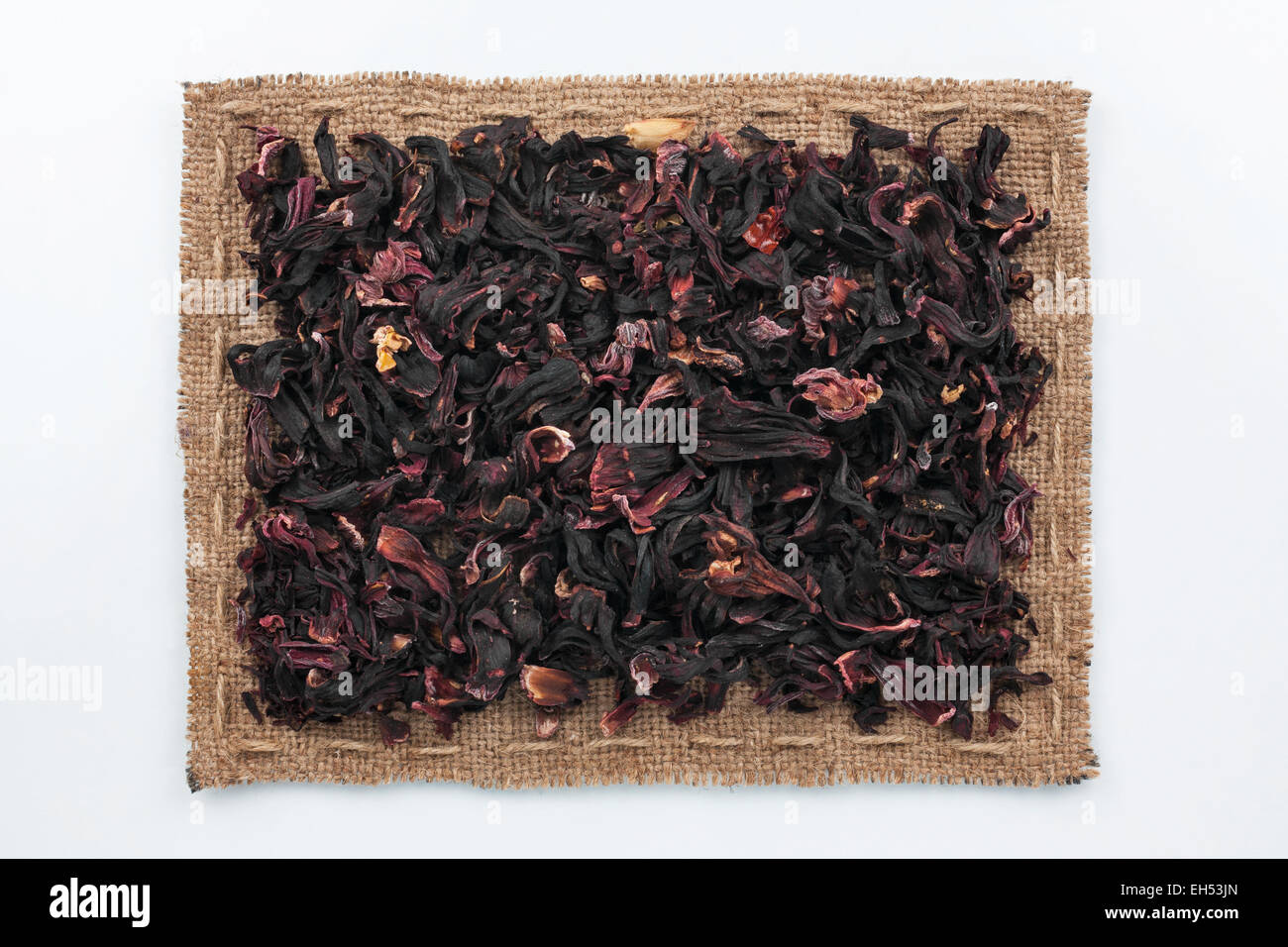 Frame of burlap and hibiscus, lying on a white background Stock Photo