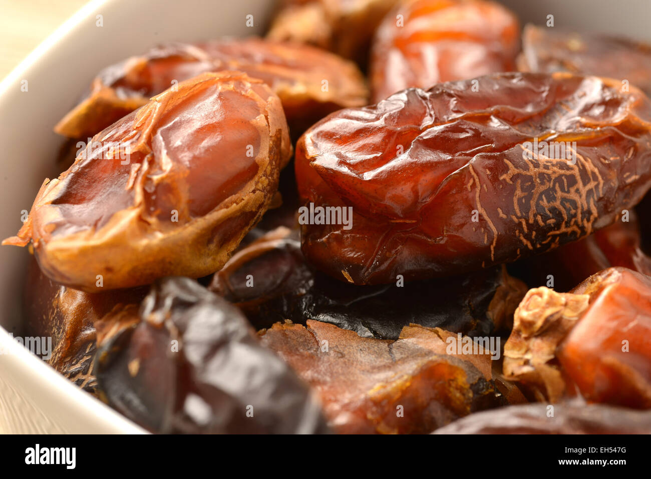 A photo of a pile of dates in a bowl Stock Photo