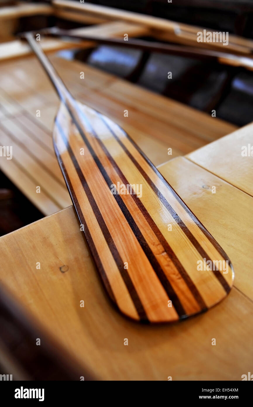 Detail shot with a new wooden paddle in a canoe Stock Photo