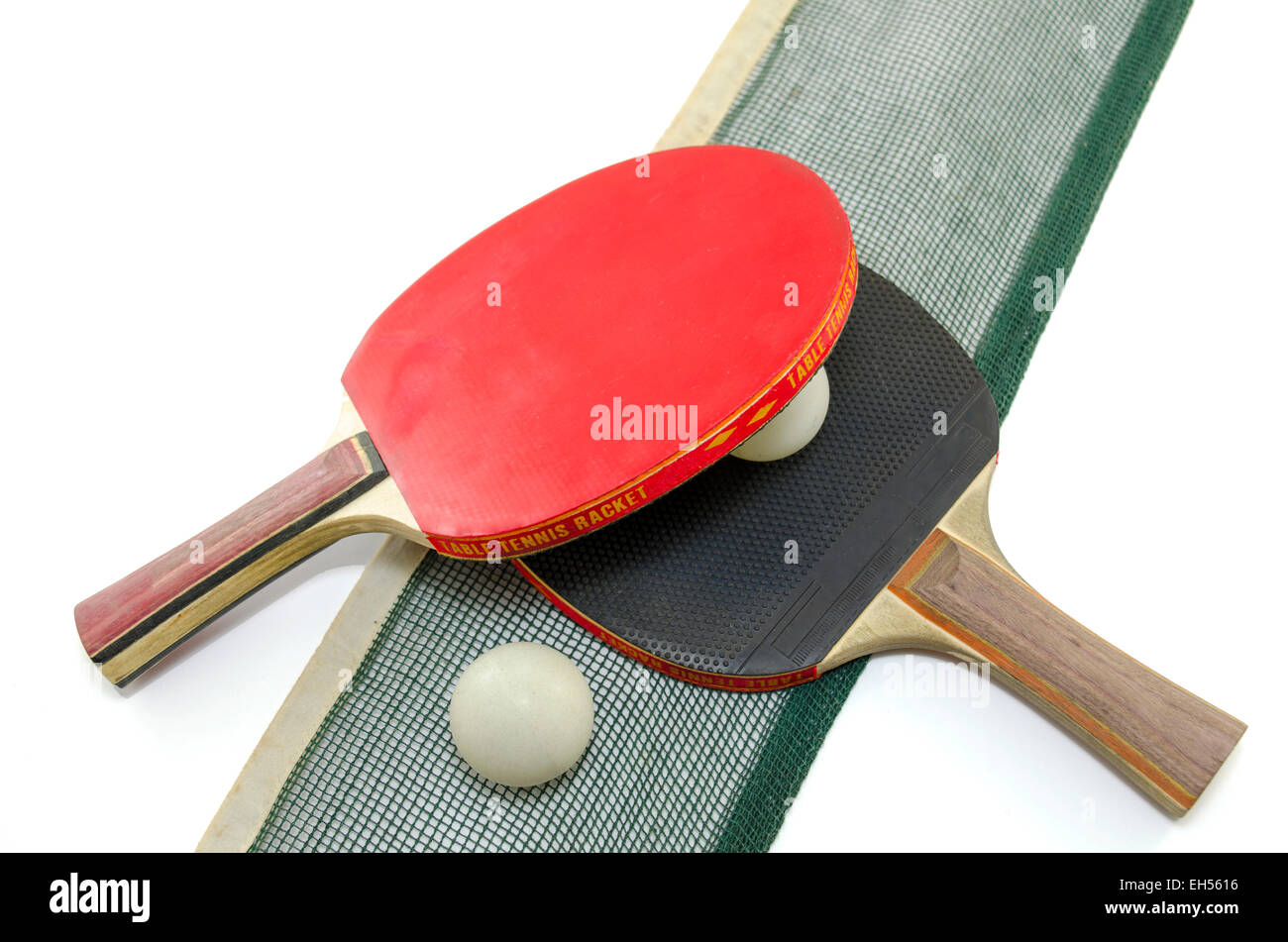 Two table tennis rackets and an old net isolated on white Stock Photo
