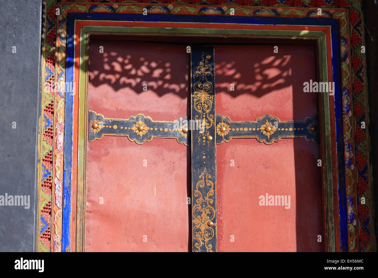 Red Painted Wooden Door With Black And Gold Painted