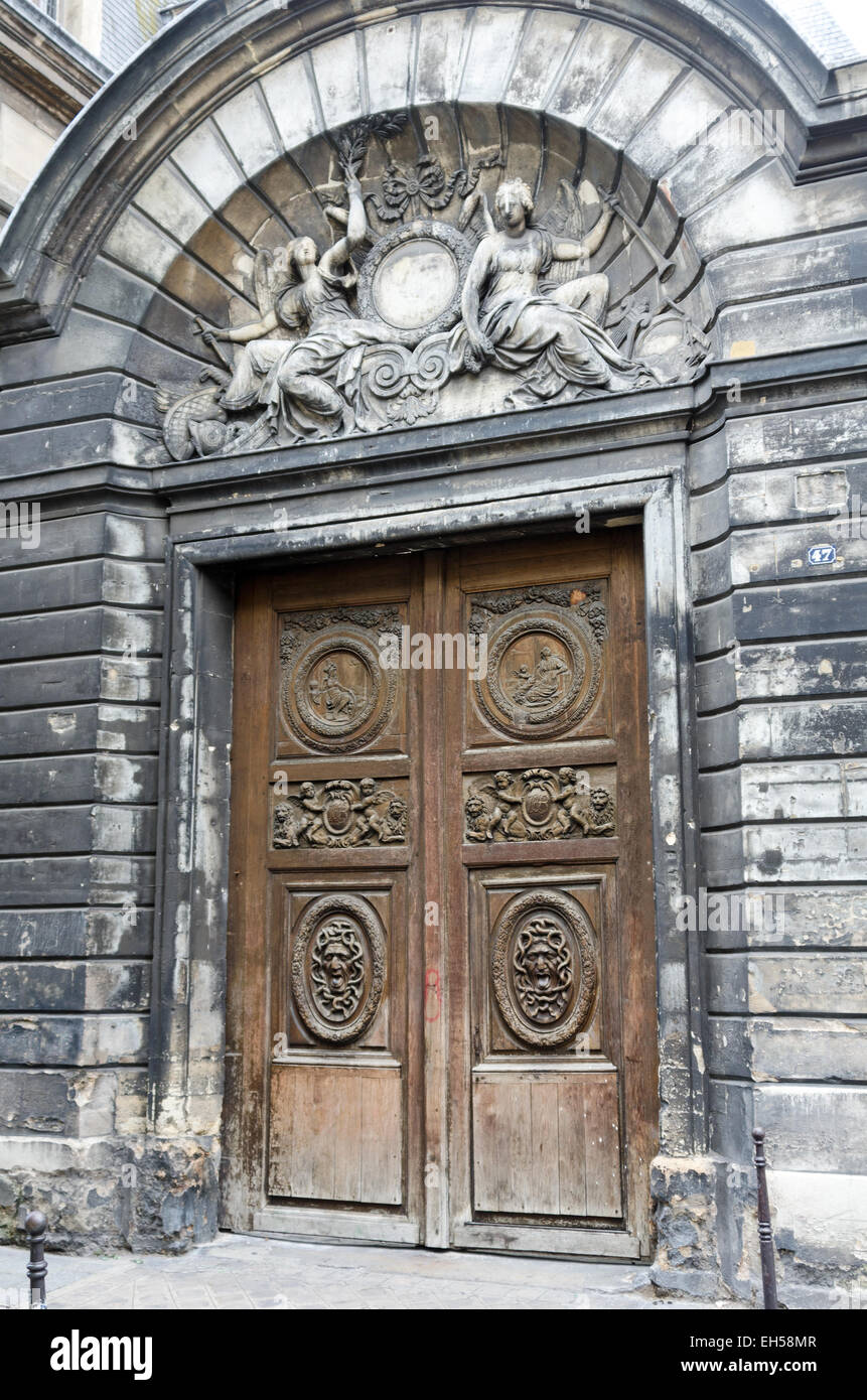 Gates of the Hôtel Amelot de Bisseuil in Paris, by the architect Pierre Cottard. Bas-relief above the door by Thomas Regnaudin. Stock Photo