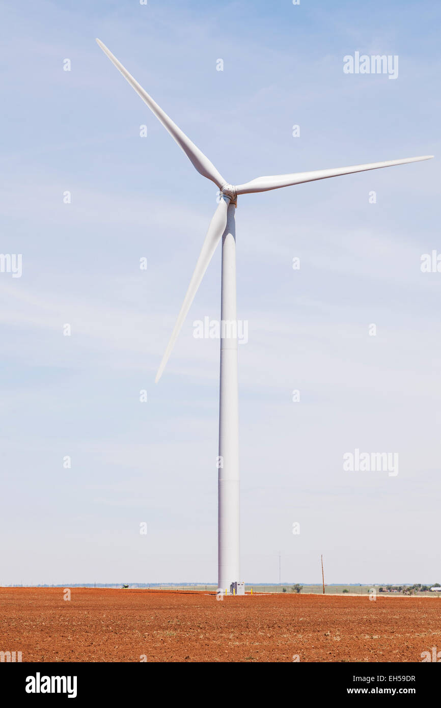 Windmill for generating electricity in freshly plowed hay field with heat shimmer, Kiowa County, Oklahoma Stock Photo