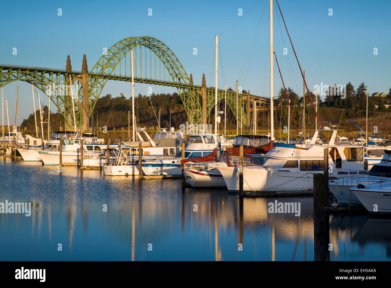 Dawn in Newport Harbor with Yaquina Bay Bridge beyond, Newport, Oregon, USA Stock Photo