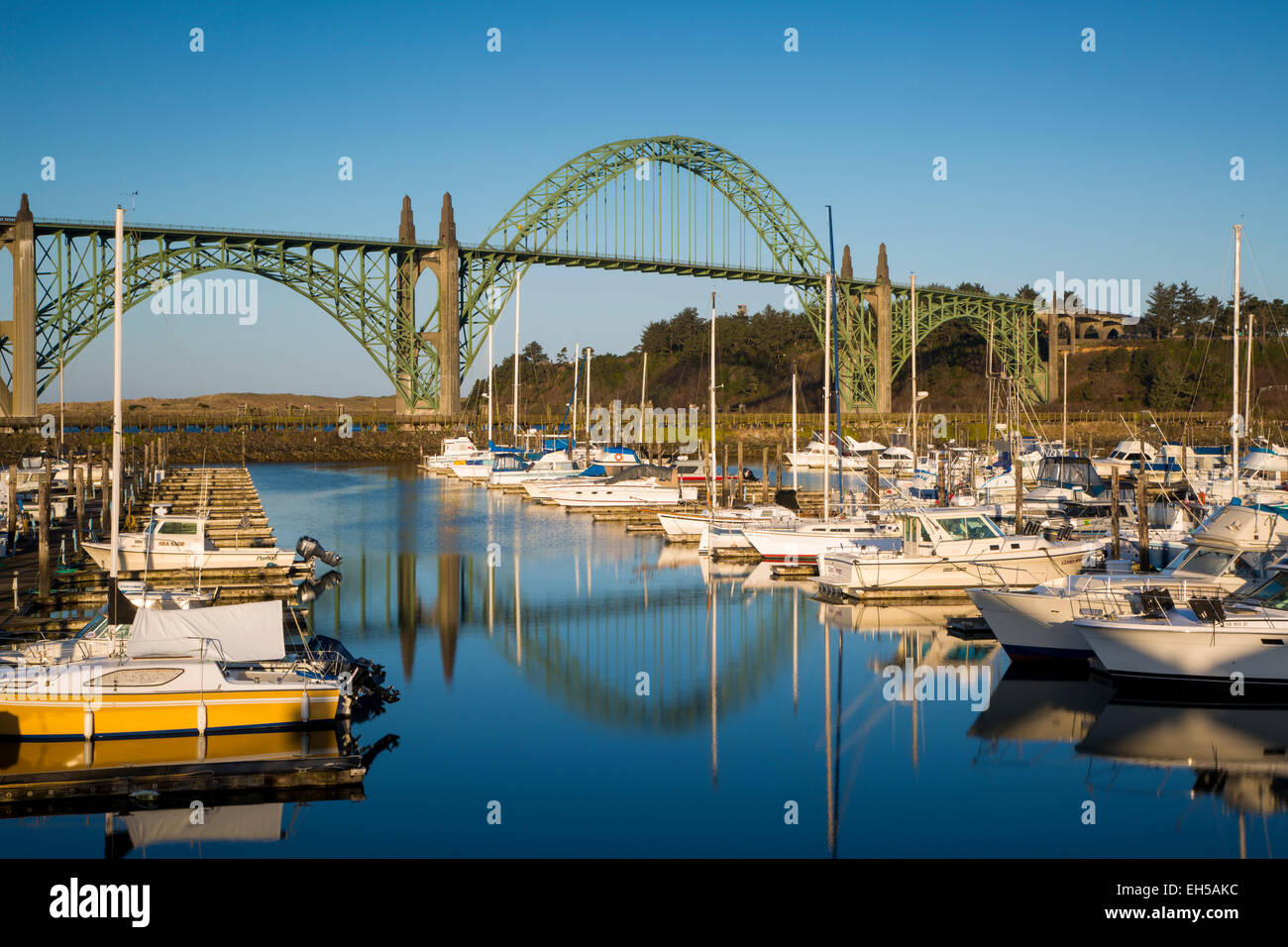 Dawn in Newport Harbor with Yaquina Bay Bridge beyond, Newport, Oregon, USA Stock Photo