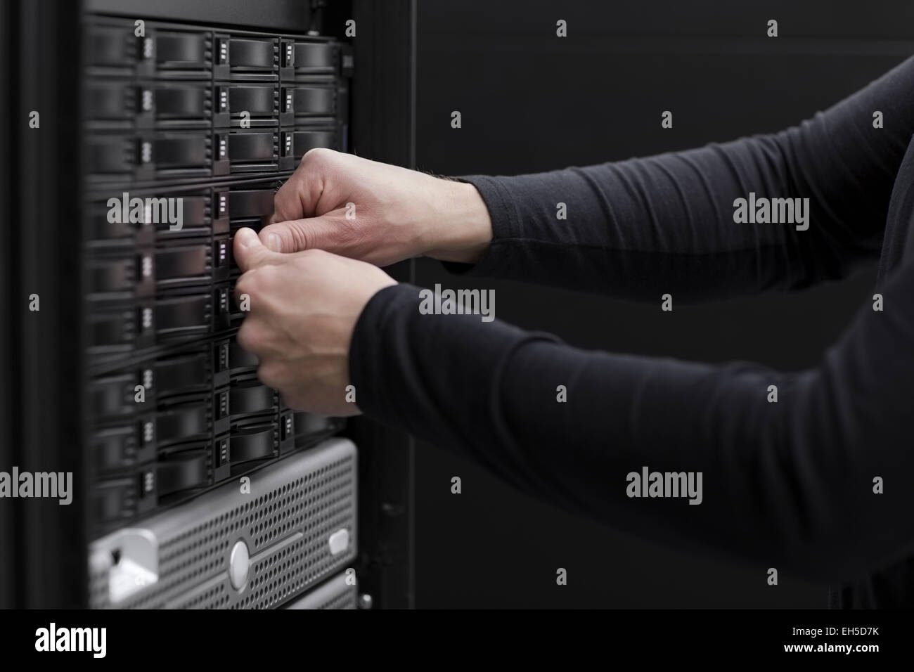 It engineer / technician working in a data center. This enclosures is a