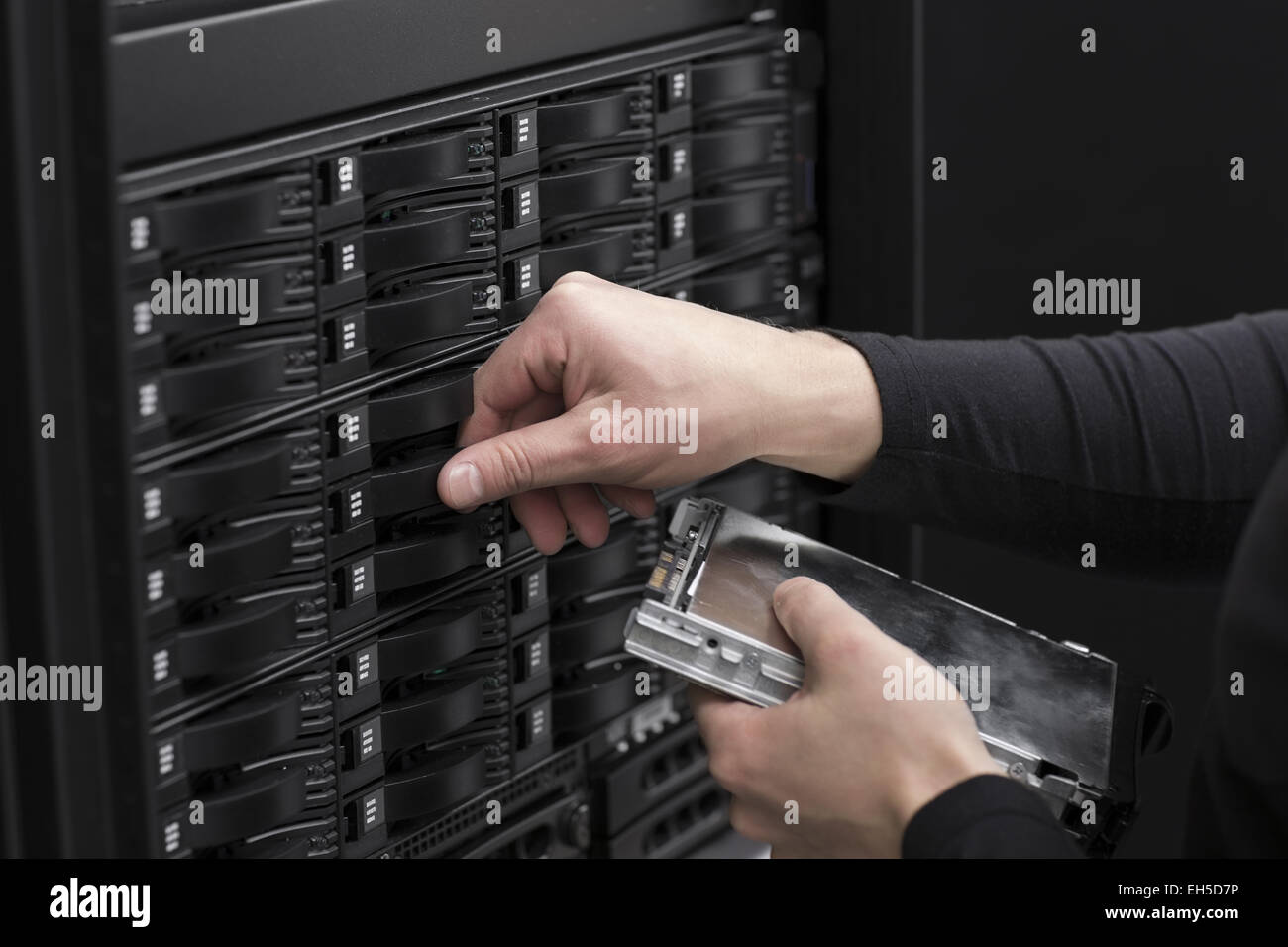 It engineer / technician working in a data center. This enclosures is a