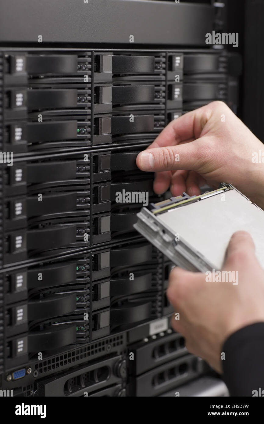 It engineer / technician working in a data center. This enclosures is a